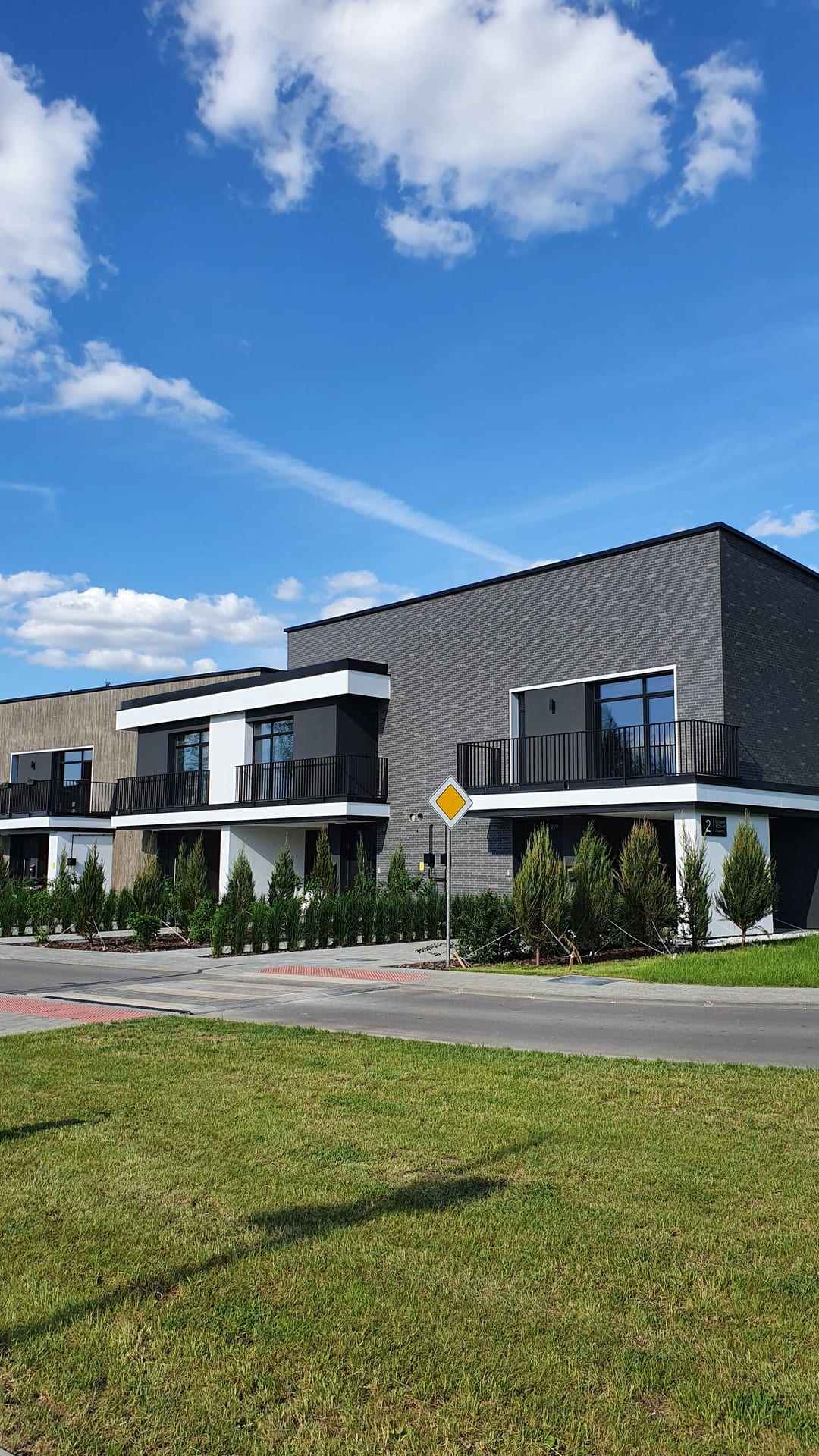 Contemporary homes under a clear blue sky in Minsk, Belarus.